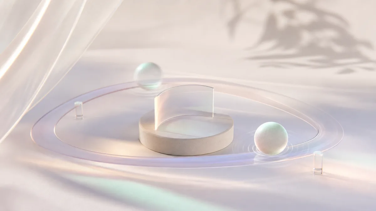 A disc on a podium encircled by an orbiting glass ring and drifting spheres